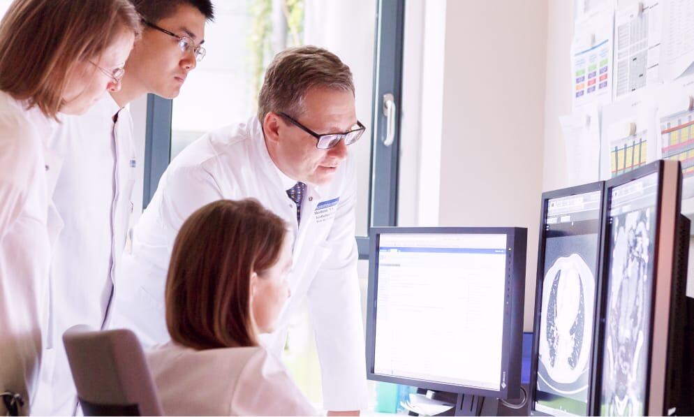 Medical research team examining brain scan images for neurological studies.